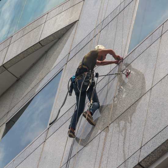 Man cleaning high level windows